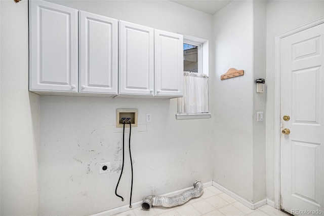 clothes washing area featuring cabinet space, electric dryer hookup, hookup for a washing machine, and baseboards