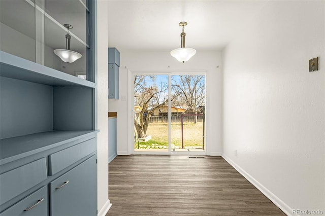 doorway to outside with dark wood-type flooring and baseboards