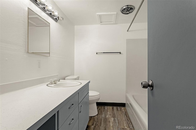 bathroom featuring visible vents, vanity, toilet, and wood finished floors