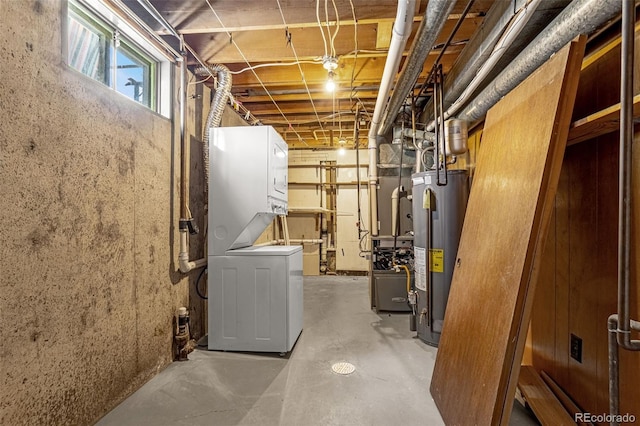 below grade area featuring stacked washer / dryer and gas water heater