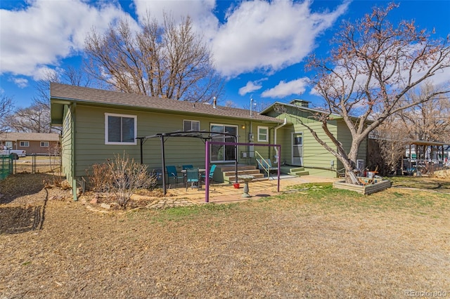 view of front facade featuring a front lawn, a patio area, and fence