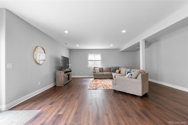 living room featuring baseboards, recessed lighting, and dark wood-type flooring