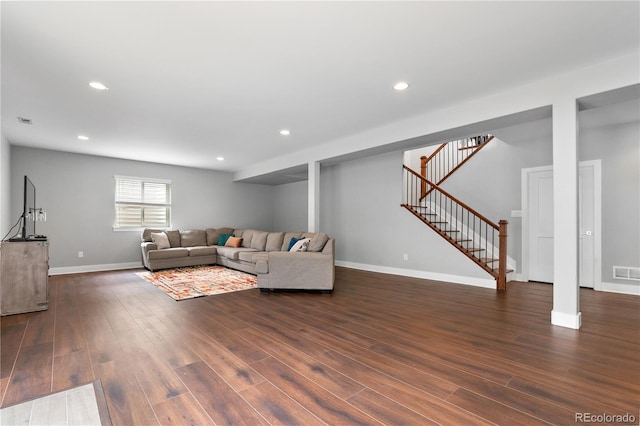 living room with stairway, dark wood-style flooring, baseboards, visible vents, and recessed lighting