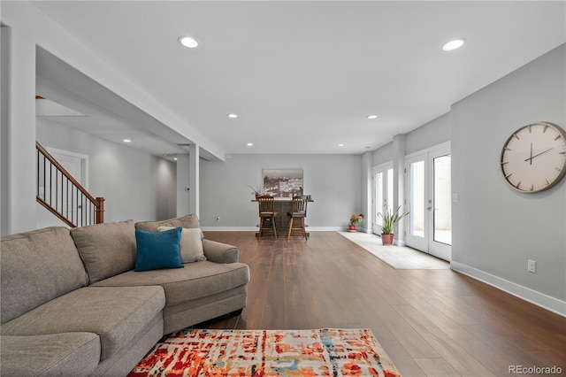 living room featuring baseboards, recessed lighting, and dark wood-style floors
