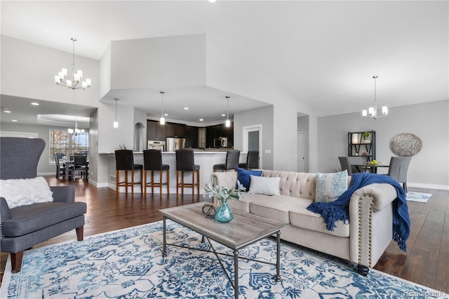 living room with recessed lighting, a notable chandelier, baseboards, and wood finished floors