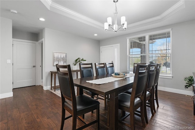 dining room with ornamental molding, a raised ceiling, and a chandelier