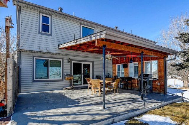 snow covered house with a patio