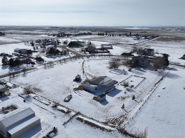 snowy aerial view featuring a rural view