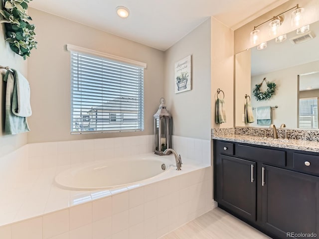 11902 Norfolk Ct, Commerce City, CO 80022 - bathroom with vanity and a garden tub