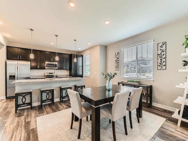 11902 Norfolk Ct, Commerce City, CO 80022 - dining room with light wood finished floors and recessed lighting