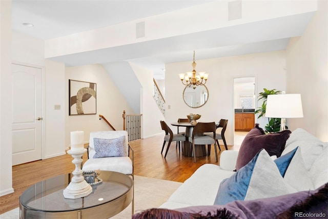 443 Garfield St, Denver, CO 80206 - living room featuring a chandelier, light wood-style floors, and stairs