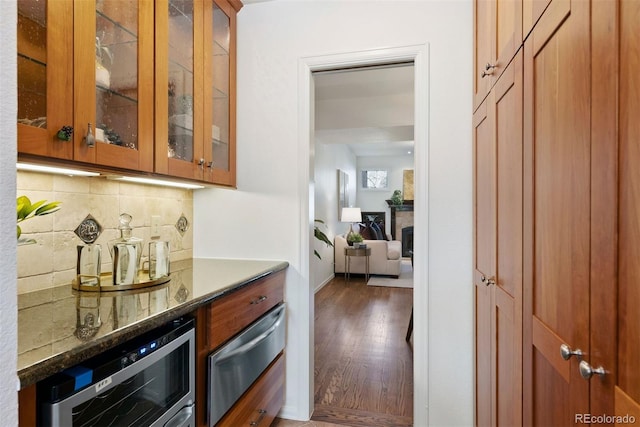 443 Garfield St, Denver, CO 80206 - indoor dry bar featuring a warming drawer, decorative backsplash, wood finished floors, beverage cooler, and baseboards