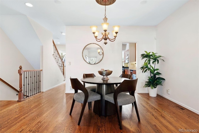 443 Garfield St, Denver, CO 80206 - dining space featuring a chandelier, wood finished floors, baseboards, recessed lighting, and stairway