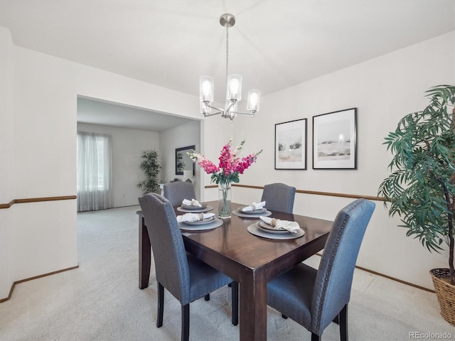 6898 W Nova Dr, Littleton, CO 80128 - dining area featuring light colored carpet, a chandelier, and baseboards