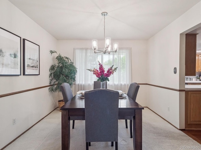 6898 W Nova Dr, Littleton, CO 80128 - dining room featuring a chandelier, light colored carpet, and baseboards