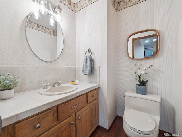 6898 W Nova Dr, Littleton, CO 80128 - half bathroom featuring wood finished floors, vanity, and toilet