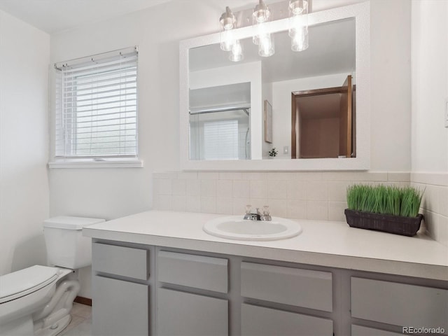 6898 W Nova Dr, Littleton, CO 80128 - full bathroom featuring vanity, tasteful backsplash, toilet, and a shower with door