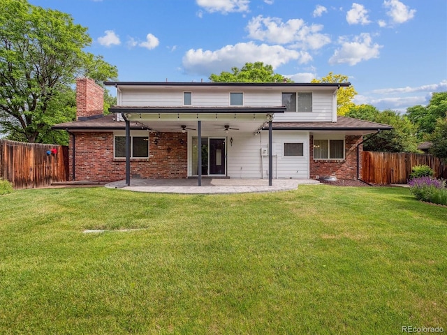 6898 W Nova Dr, Littleton, CO 80128 - back of house featuring ceiling fan, a patio area, brick siding, and a chimney