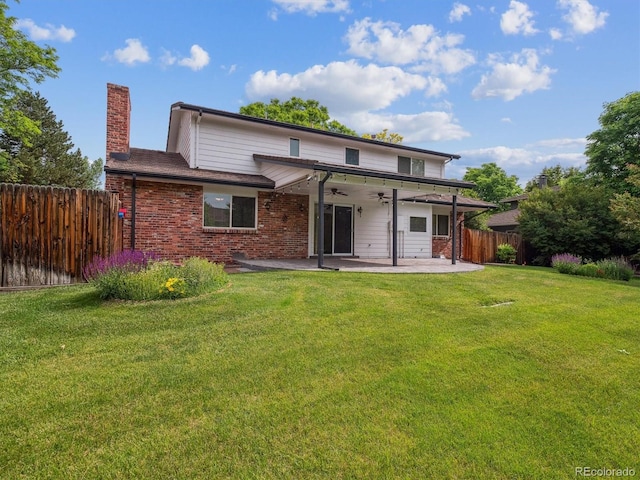 6898 W Nova Dr, Littleton, CO 80128 - rear view of house with a ceiling fan, a patio, a chimney, and brick siding