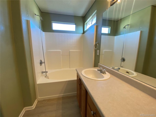 full bathroom featuring vanity, wood finished floors, and bathing tub / shower combination