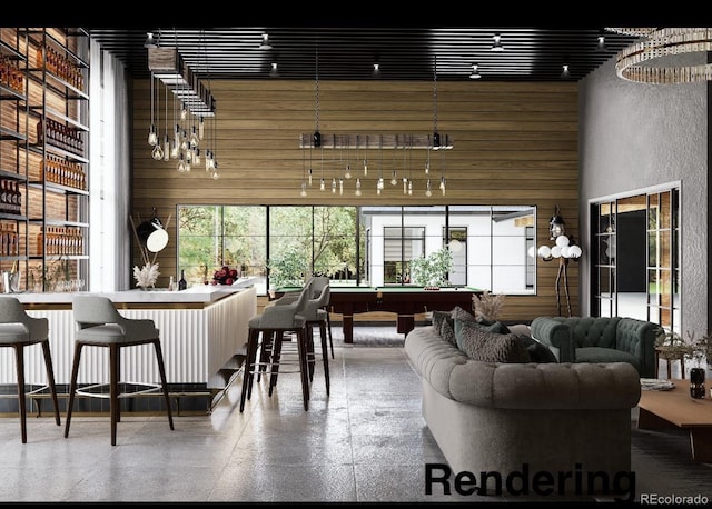 interior space featuring a towering ceiling, pool table, and wood walls