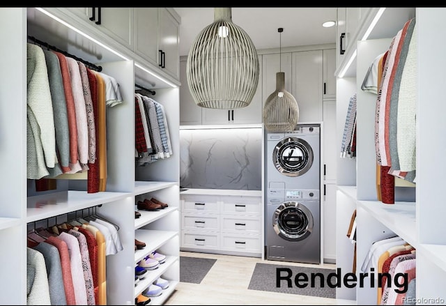 clothes washing area featuring cabinets, stacked washer / drying machine, and light hardwood / wood-style flooring