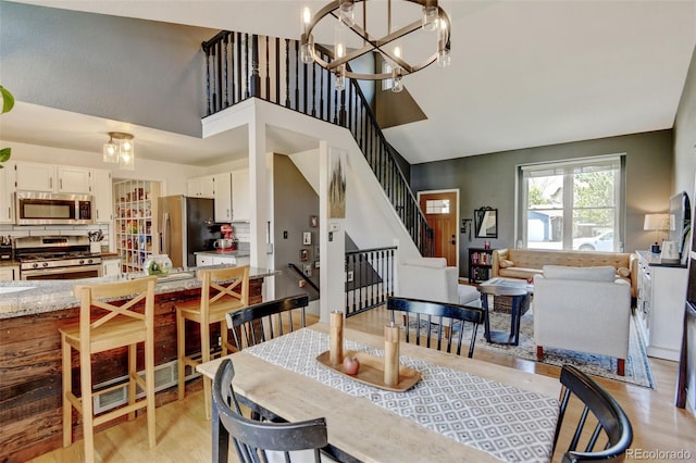 8680 Apache Plume Dr, Parker, CO 80134 - dining space with a towering ceiling, a chandelier, and stairway