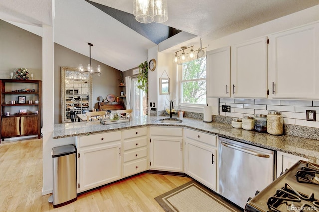 8680 Apache Plume Dr, Parker, CO 80134 - kitchen with a chandelier, stainless steel dishwasher, a sink, light wood-type flooring, and vaulted ceiling