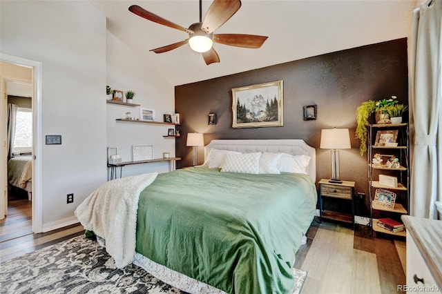 8680 Apache Plume Dr, Parker, CO 80134 - bedroom featuring wood finished floors, lofted ceiling, ceiling fan, and baseboards