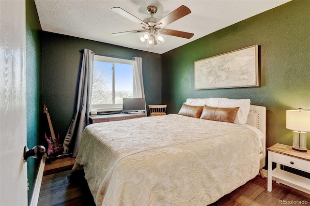 8680 Apache Plume Dr, Parker, CO 80134 - bedroom featuring a textured wall, wood finished floors, and a ceiling fan