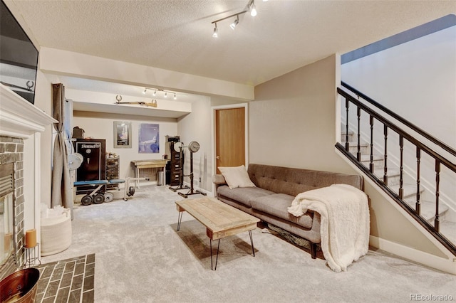 8680 Apache Plume Dr, Parker, CO 80134 - carpeted living room with track lighting, stairway, a textured ceiling, a stone fireplace, and baseboards