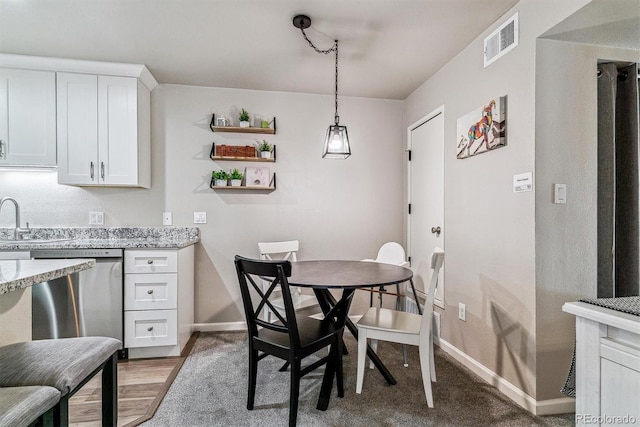 dining area featuring hardwood / wood-style flooring and sink