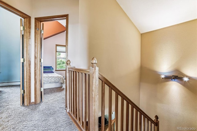 hall with baseboard heating, carpet, and high vaulted ceiling