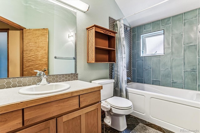 full bathroom featuring vanity, toilet, shower / bath combo with shower curtain, and vaulted ceiling