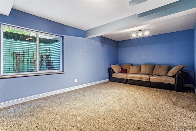 living room with beamed ceiling and carpet floors