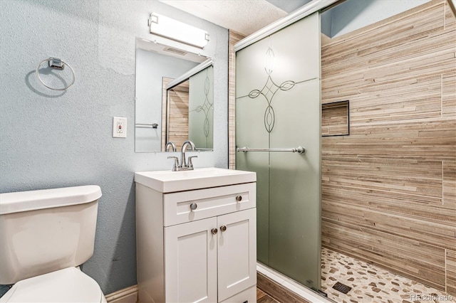 bathroom with vanity, toilet, and an enclosed shower