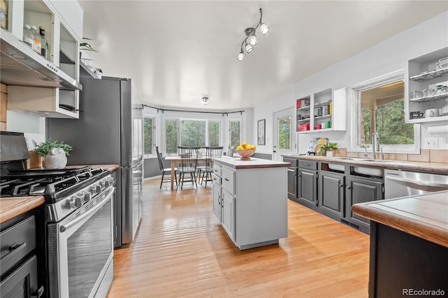50 Victoria Rd, Pine, CO 80470 - kitchen with appliances with stainless steel finishes, open shelves, a sink, a center island, and healthy amount of natural light