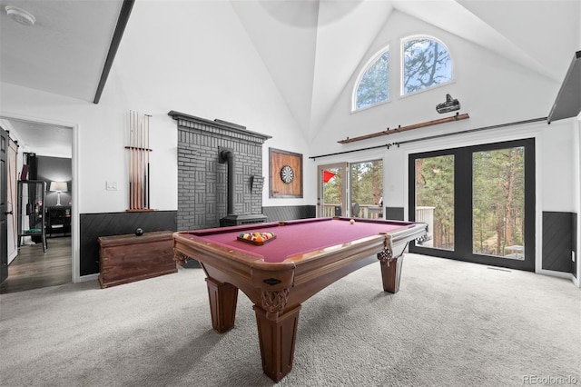 50 Victoria Rd, Pine, CO 80470 - game room with carpet floors, a wood stove, high vaulted ceiling, wainscoting, and billiards