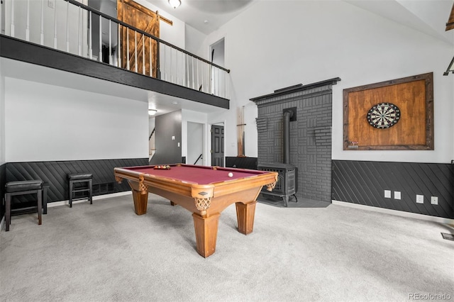 50 Victoria Rd, Pine, CO 80470 - rec room featuring carpet floors, a wood stove, high vaulted ceiling, a wainscoted wall, and billiards