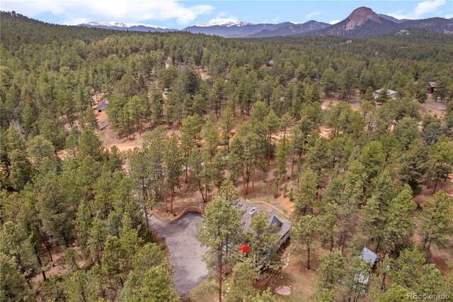 50 Victoria Rd, Pine, CO 80470 - aerial view of property's location featuring a heavily wooded area and a mountain backdrop