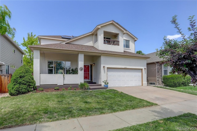 5757 W Alamo Dr, Denver, CO 80123 - view of front of property featuring stucco siding, an attached garage, driveway, and solar panels
