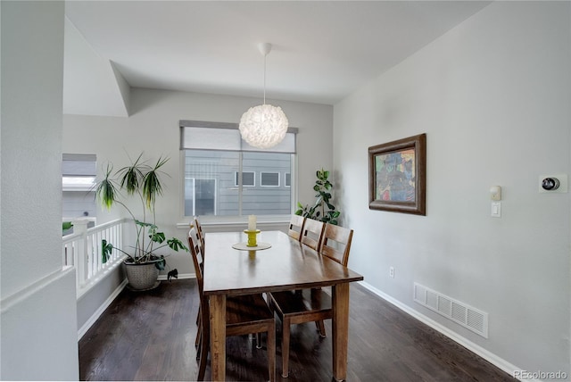 5757 W Alamo Dr, Denver, CO 80123 - dining area with dark wood-style flooring, a chandelier, baseboards, and healthy amount of natural light