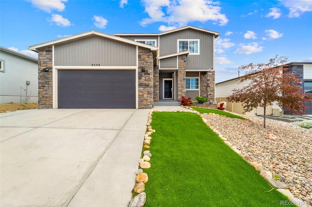 9869 Meridian Hills Trl, Peyton, CO 80831 - view of front of home featuring stone siding, a garage, concrete driveway, and a front yard