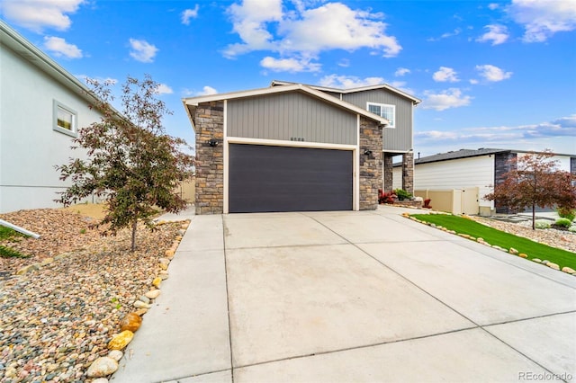 9869 Meridian Hills Trl, Peyton, CO 80831 - contemporary house with stone siding, concrete driveway, and a garage
