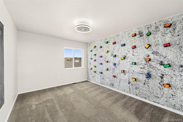 9869 Meridian Hills Trl, Peyton, CO 80831 - unfurnished room featuring carpet flooring, wallpapered walls, and an accent wall