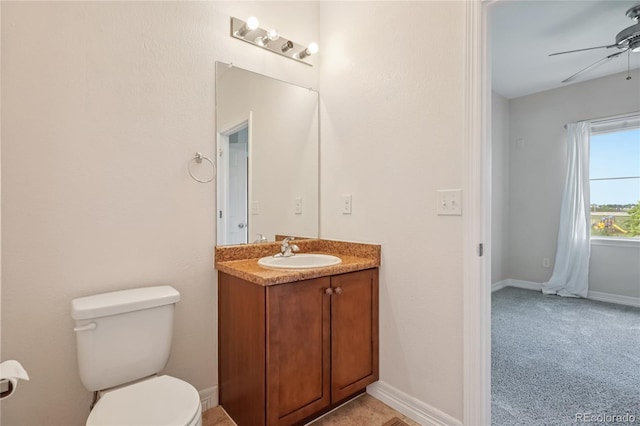 12921 Grant Cir Unit B, Thornton, CO 80241 - bathroom featuring a ceiling fan, toilet, vanity, and baseboards