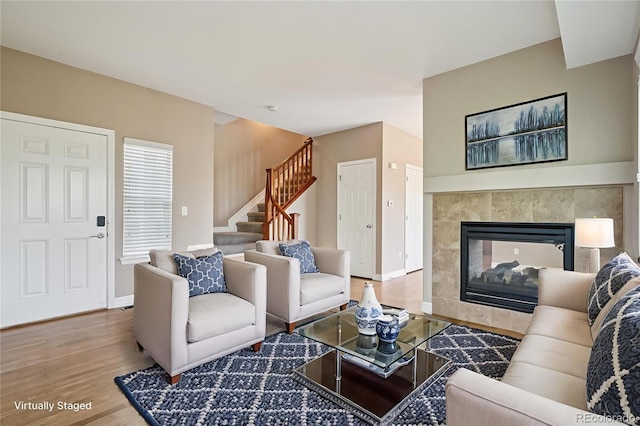 12921 Grant Cir Unit B, Thornton, CO 80241 - living area with wood finished floors, stairs, and a tile fireplace