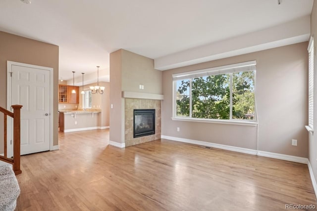12921 Grant Cir Unit B, Thornton, CO 80241 - unfurnished living room with light wood-style floors, baseboards, and a fireplace