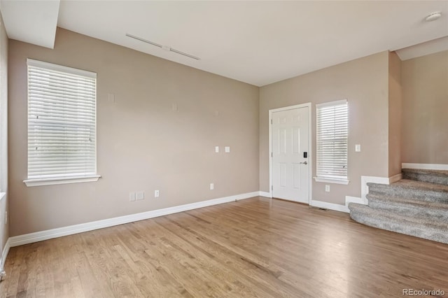 12921 Grant Cir Unit B, Thornton, CO 80241 - spare room featuring baseboards, light wood finished floors, stairs, and a smoke detector