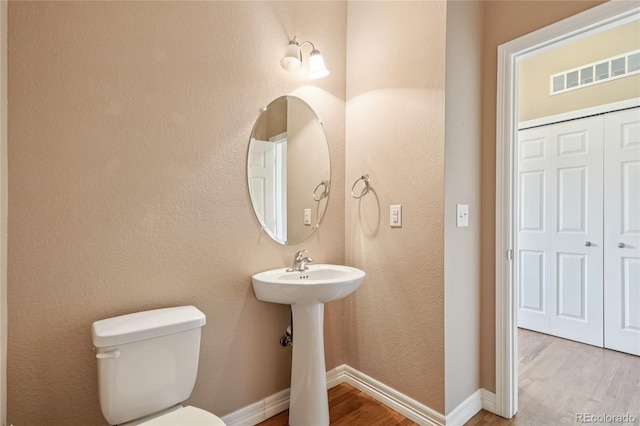 12921 Grant Cir Unit B, Thornton, CO 80241 - bathroom featuring wood finished floors and toilet